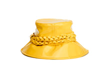 Load image into Gallery viewer, A bright yellow glossy bucket hat featuring a wide brim and a thick braided rope detail wrapped around the crown, shown against a plain white background. Back