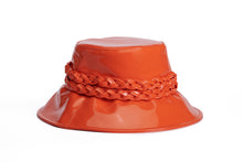 Load image into Gallery viewer, A glossy orange bucket hat with a wide brim and a braided orange band around the crown, shown on a plain white background.