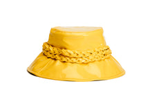 Load image into Gallery viewer, A bright yellow glossy bucket hat featuring a wide brim and a thick braided rope detail wrapped around the crown, shown against a plain white background. Side