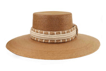 Load image into Gallery viewer, Darker straw hat with a decorative band on a white background