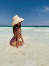 Load image into Gallery viewer, Girl posing in the beach with a straw hat bucket shape
