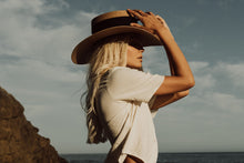Load image into Gallery viewer, Girl posing in the beach with the "Isla Bonita" hat in tan color