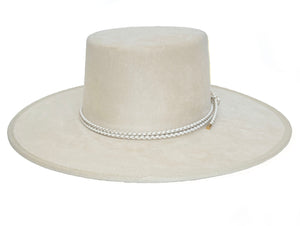 White suede hat with a boater crown and finished with a statement bolo braid, front view