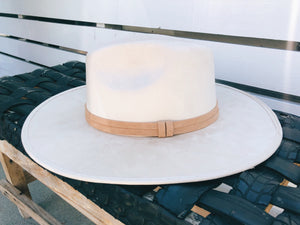 Suede hat with the crown shaped into a clean and ridged design with a double synthetic suede tan trim, left side view