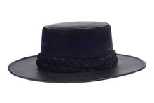 Load image into Gallery viewer, Hat swathed in rich black velour fabric and a brim made of black synthetic leather with a double braid velour trim, left side view
