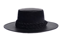 Load image into Gallery viewer, Hat swathed in rich black velour fabric and a brim made of black synthetic leather with a double braid velour trim, front view