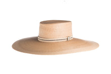 Load image into Gallery viewer, Hat with a flat top crown braid with palm leaves in natural color and an embroidered trim, left side view