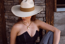 Load image into Gallery viewer, Girl with a western hat is wearing a gold heart necklace.
