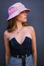 Load image into Gallery viewer, Girl with a pink bucket hat is wearing a gold heart necklace.
