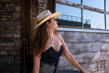 Load image into Gallery viewer, Girl with a western hat is wearing a gold heart necklace.
