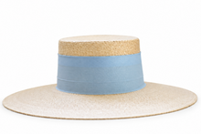 Load image into Gallery viewer, A wide-brimmed boater-style hat with a natural straw body and a light blue fabric band around the crown.

