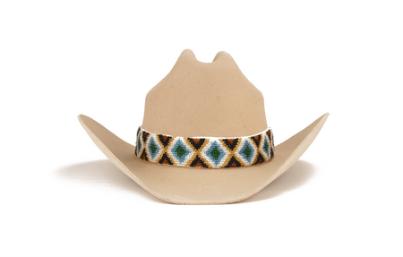 A light tan cowboy hat with a decorative beaded band featuring a geometric diamond pattern in black, white, blue, and brown, set against a plain white background.