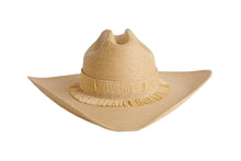 Load image into Gallery viewer, A light tan woven straw cowboy hat with a wide brim, a tall crown, and a decorative fringed band, shown against a plain white background.
