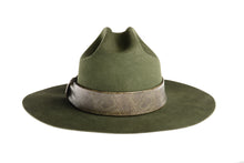 Load image into Gallery viewer, Hat made of fine olive green wool, this consists of a stiffened double-peak crown and ironed wide brim which is complemented by a faux snakeskin trim, back view
