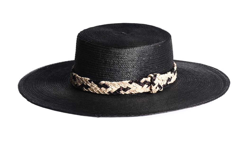 Wide black brim palm hat with woven straw trim in a crisscross design, left side view