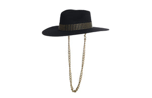 Black hat composed of the finest wool, it has an elegant structured crown, finished with a studded trim that defines the body of the hat. It comes with a detachable gold chain, left side view