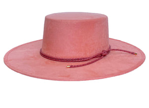 Vegan suede hat in pink color with a cordobes style and finished with a statement double braid, left side view