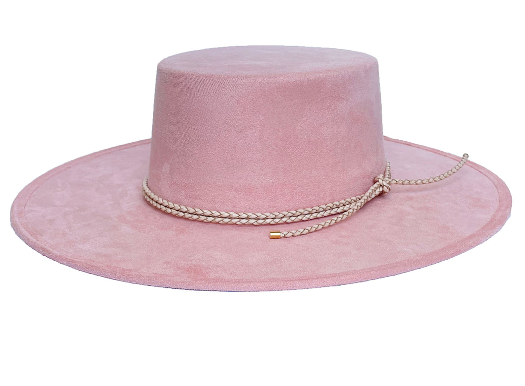 Vegan suede hat in soft pink color, finished with a statement double braid, left side view