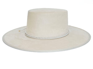 White suede hat with a boater crown and finished with a statement bolo braid, right side view