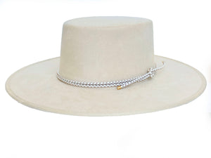 White suede hat with a boater crown and finished with a statement bolo braid, left side view
