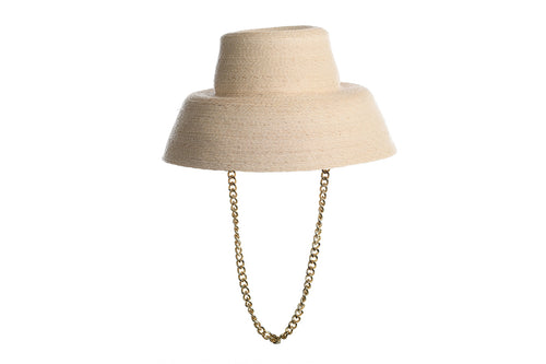 Straw hat bucket shape in natural color made of palm leaves finished with a detachable chain, left side view