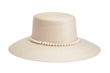 Load image into Gallery viewer, A light beige woven straw hat with a wide brim and a decorative band of white faux pearls around the crown, shown on a solid white background. Oyster side
