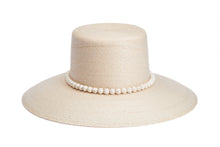 Load image into Gallery viewer, A light beige woven straw hat with a wide brim and a decorative band of white faux pearls around the crown, shown on a solid white background. Front Side
