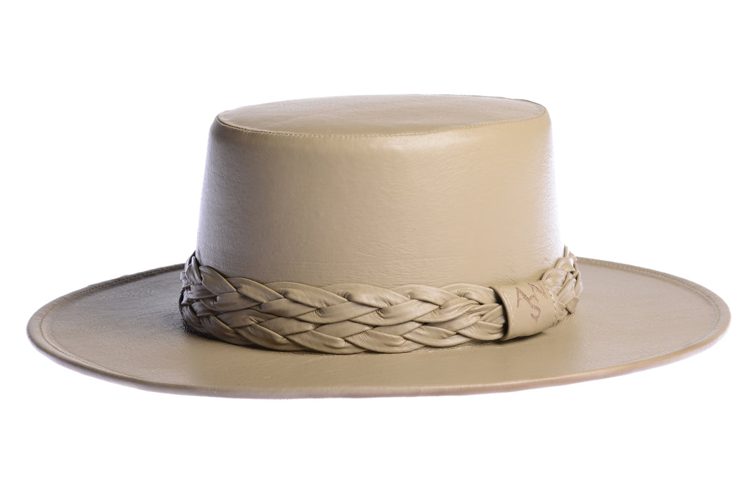 Cordobes hat in tan color crafted with an innovative metallic vegan leather made from nopal, finished with double braided trim, left side view