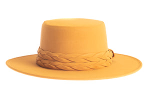 Mustard cordobes hat made of vegan leather and finished with a statement double braid, front view