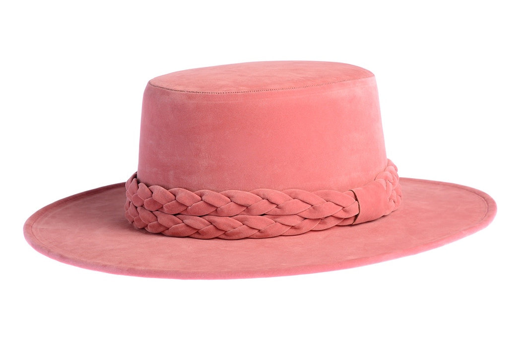 Cordobes hat composed of vibrant pink felt and with a statement double braid, left side view