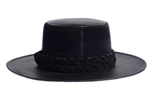 Load image into Gallery viewer, Hat swathed in rich black velour fabric and a brim made of black synthetic leather with a double braid velour trim, back view

