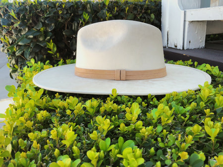 Suede hat with the crown shaped into a clean and ridged design with a double synthetic suede tan trim, left side view